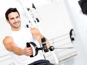 smiling man working out in the gym
