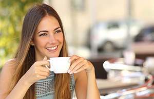 smiling woman holding a cup of tea