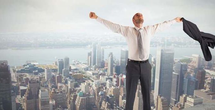 man feeling relief on top of a building