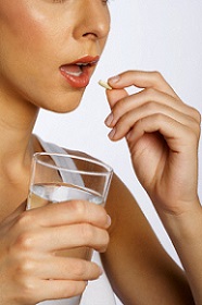 Woman Taking Pill with Water