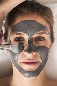 Woman Applying Clay Mask